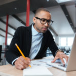 guy looking at computer, bid, calculations